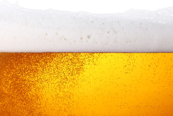 Close up background of beer with bubbles in glass