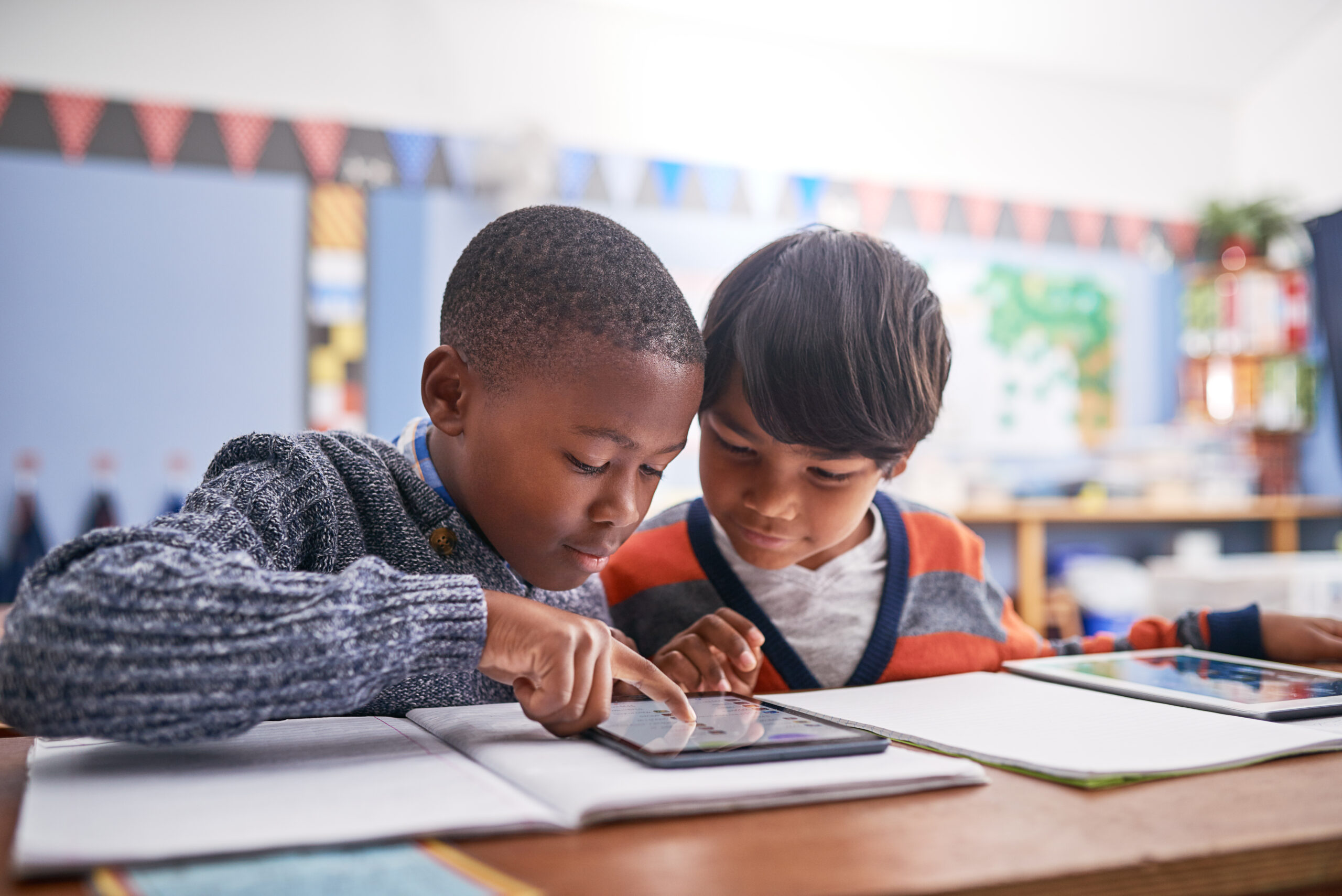 elementary school children using a tablet in class